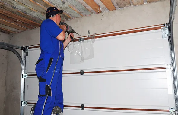 Experienced technician repairing garage door in home