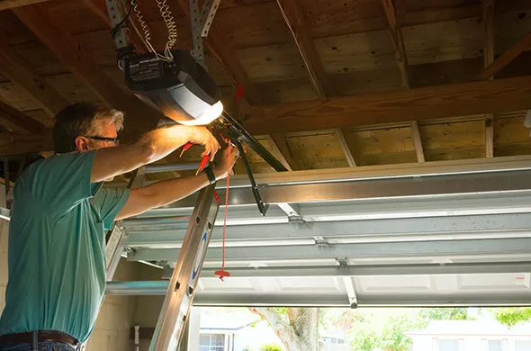 Technician performing garage door opener maintenance