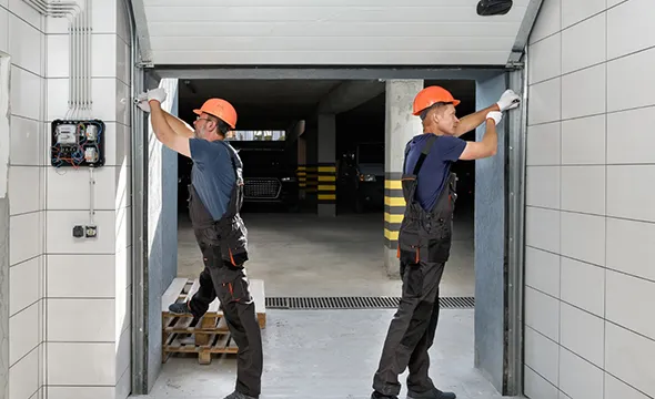 Professional technicians installing a new residential garage door.