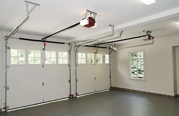 Garage door installation shown with new parts in a clean garage, highlighting a simple and useful design.